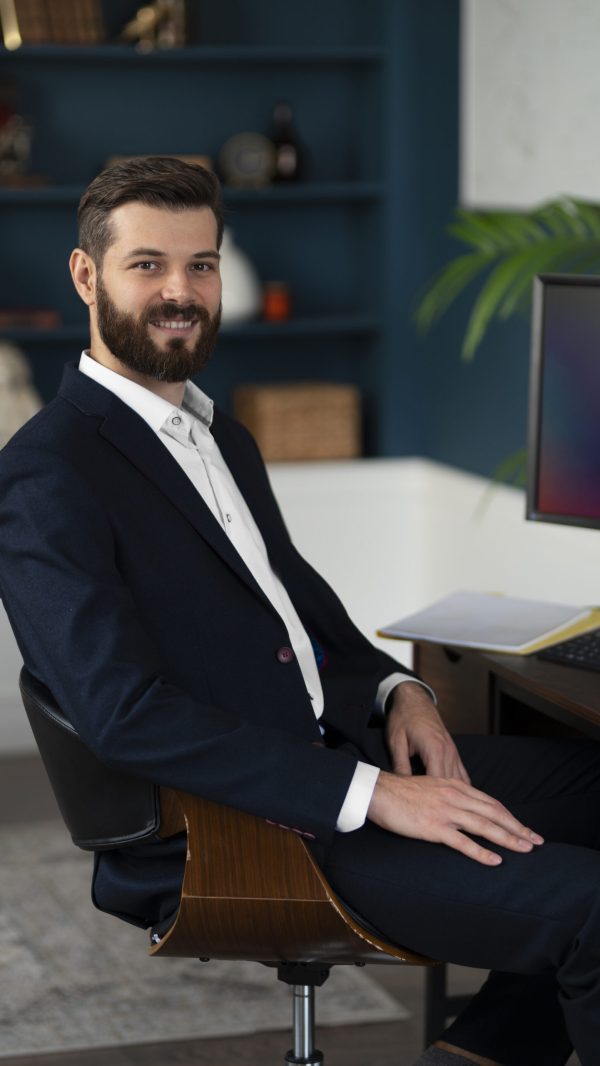 side-view-smiley-man-sitting-desk